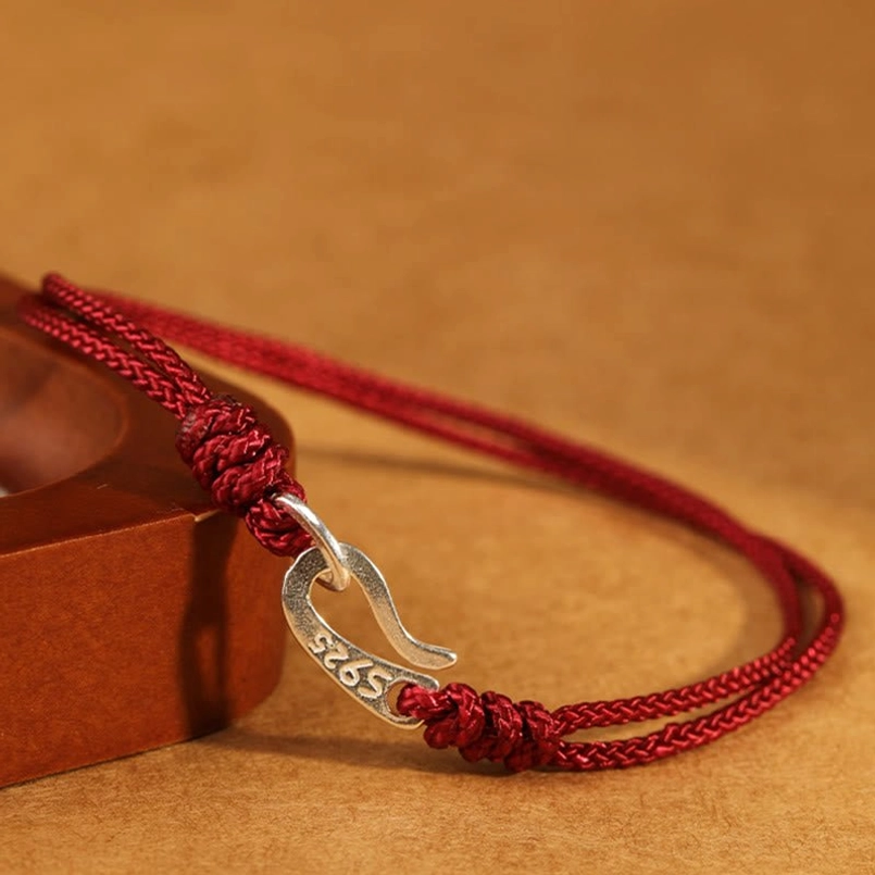 925 sterling silver red string bracelet with decorative knots side perspective view
