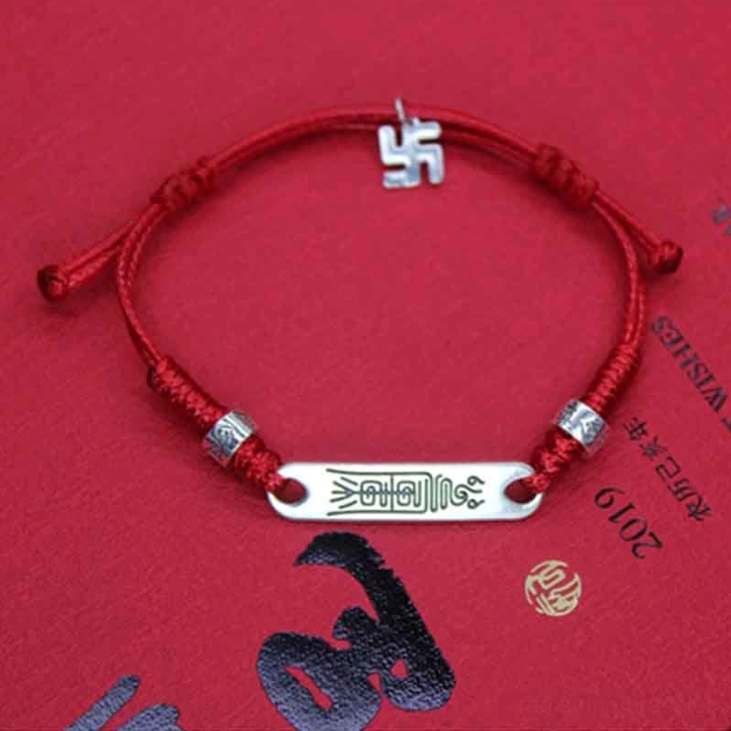 Sterling silver red string bracelet with swastika charm and engraved silver bar, Chinese style background