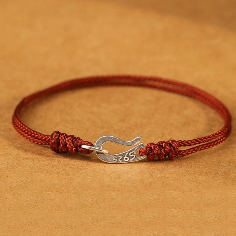 925 sterling silver red string bracelet with symmetric decorative knots flat lay