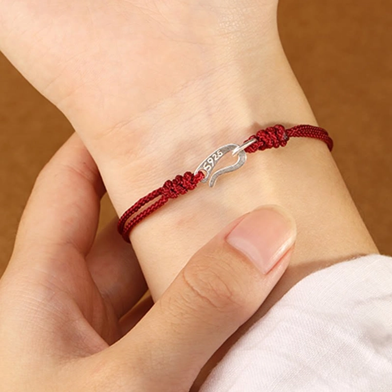 Minimalist 925 sterling silver red string bracelet worn on wrist close-up