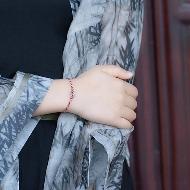 Red string bracelet with silver peace buckle detail and tourmaline beads