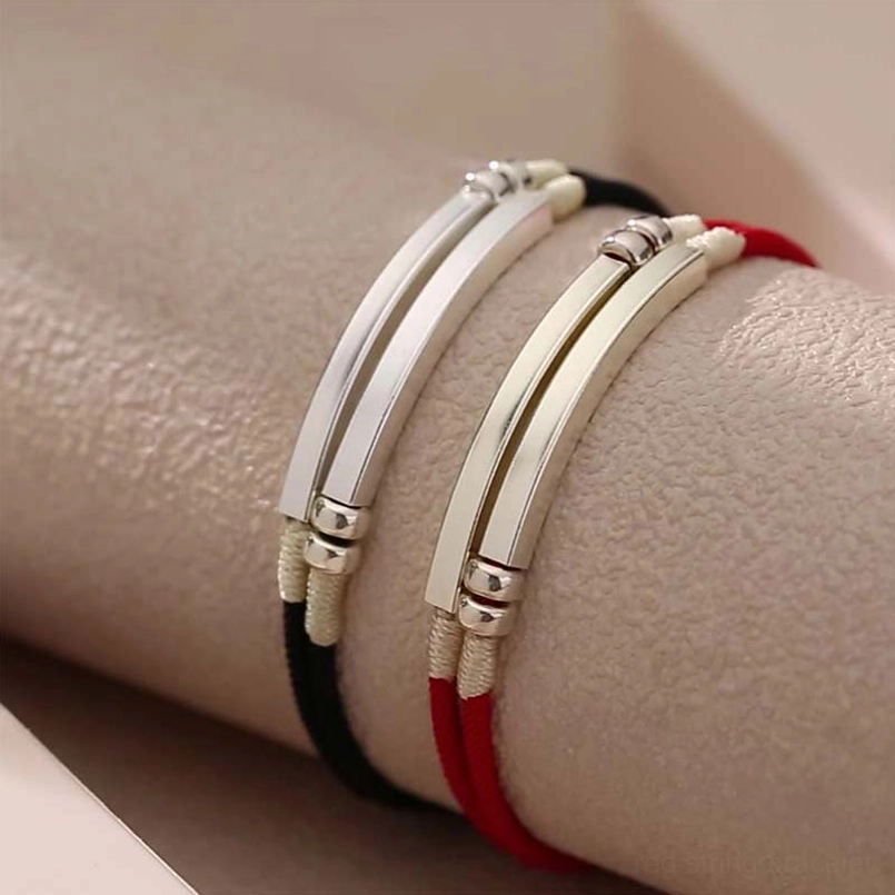 Red string bracelet with layered sterling silver accents embodying connection strength and faith
