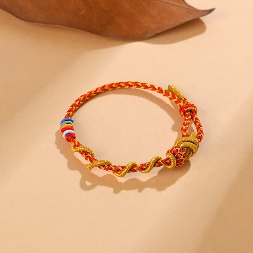 Red string Snake Year bracelet featuring traditional Chinese knot and protective symbols
