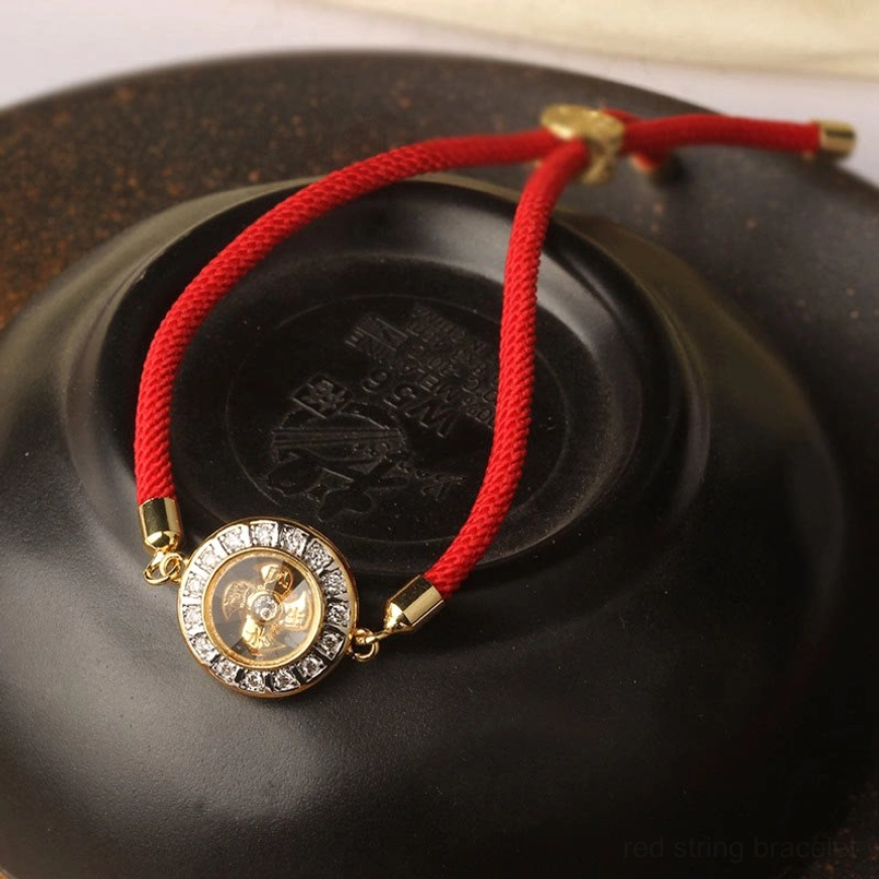 Handmade red string bracelet with copper windmill charm packaging presentation