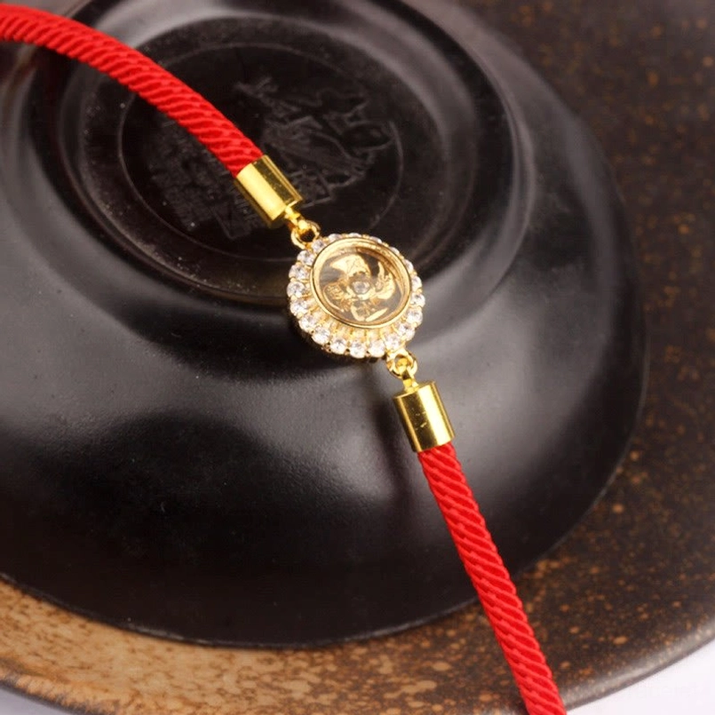 Handmade red string feng shui protection bracelet showing natural materials and artisanal craftsmanship