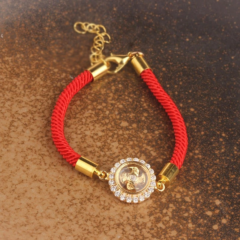 Red string feng shui windmill bracelet product lifestyle shot emphasizing protective energy and spiritual significance