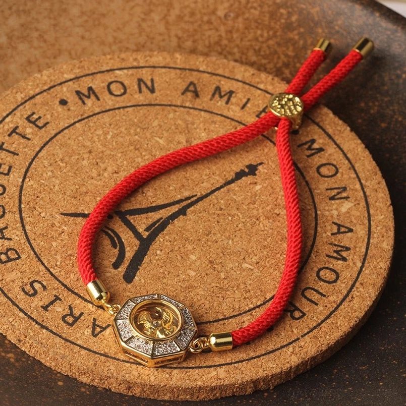 Feng shui rotating windmill red string bracelet highlighting adjustable toggle clasp and octagonal charm design