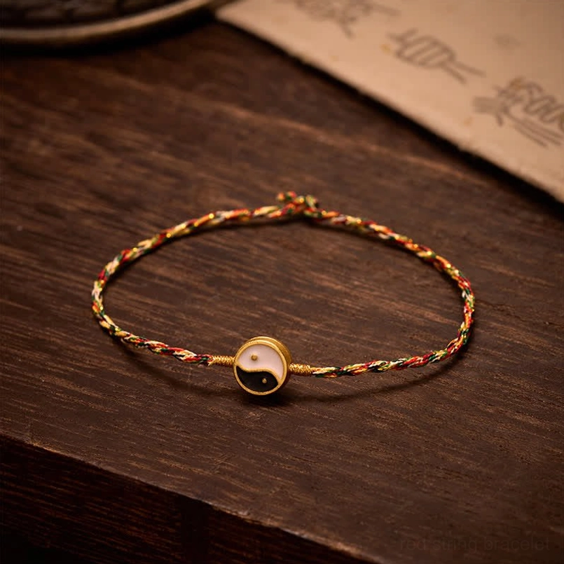 Five-color woven red string Yin Yang bracelet with gold-bordered tai chi charm and pull knot detail