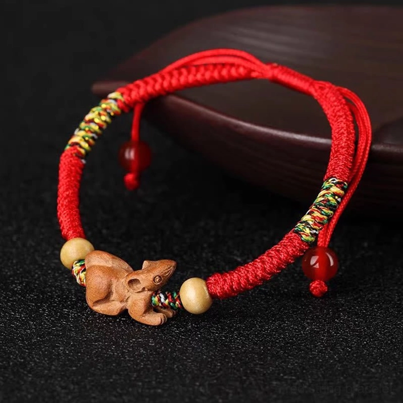 Red string peach wood zodiac bracelet with woven details
