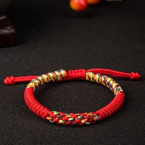 Red Tibetan King Kong Knot bracelet with multicolor woven band and adjustable drawstring - front view