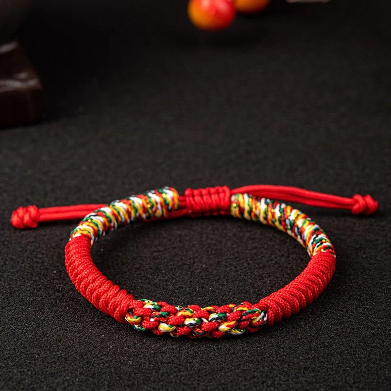 Red Tibetan King Kong Knot bracelet with multicolor woven band and adjustable drawstring - front view