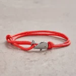 Red double wrap braided whale charm bracelet with silver metal clasp - front view