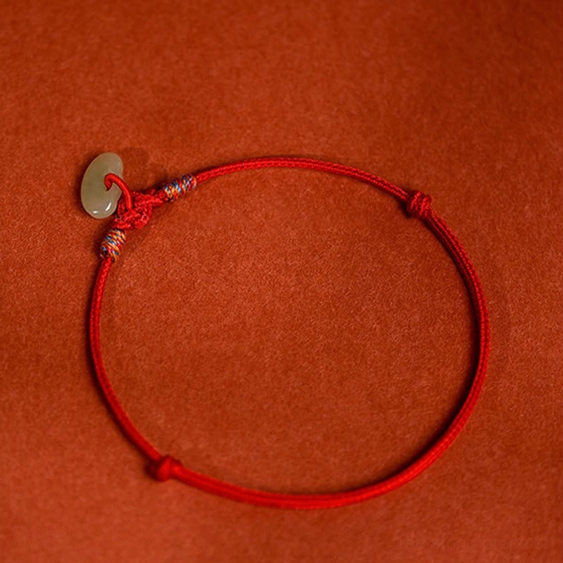 Hand-plaited red woven rope pet collar with jade donut and adjustable sliding knots