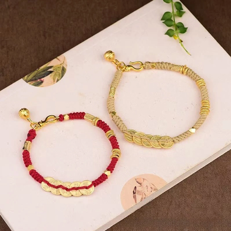 Two Styles of Five Emperor Coins Bracelets Red and Yellow Rope Flat Lay