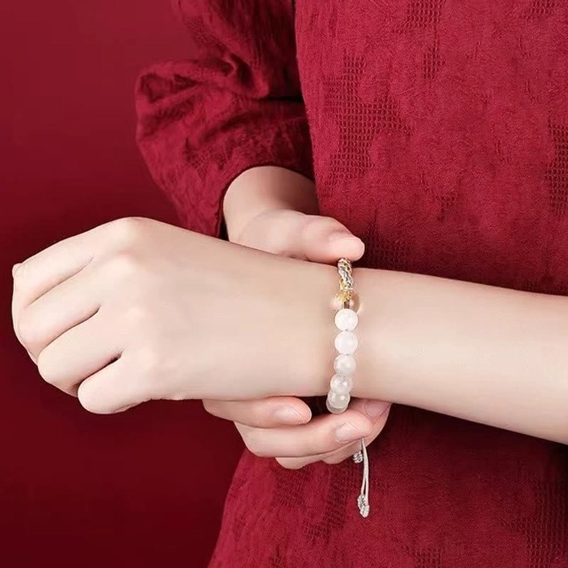 Woman wearing crystal beaded braided reincarnation knot bracelet with adjustable pull knot