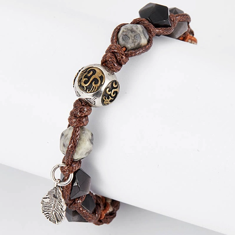 retro style red string obsidian bracelet detail shot of feather pendant