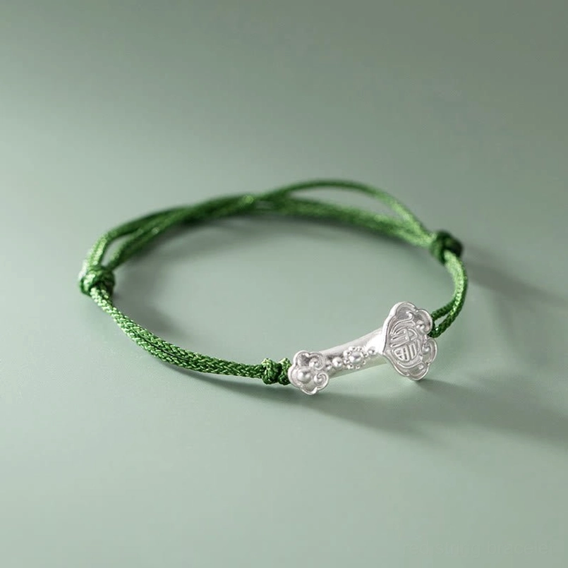Right side close up of fu character engraved 999 silver ruyi green string bracelet