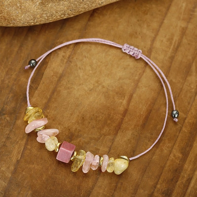 Handcrafted healing stone bracelet with pink and yellow gemstone beads close-up