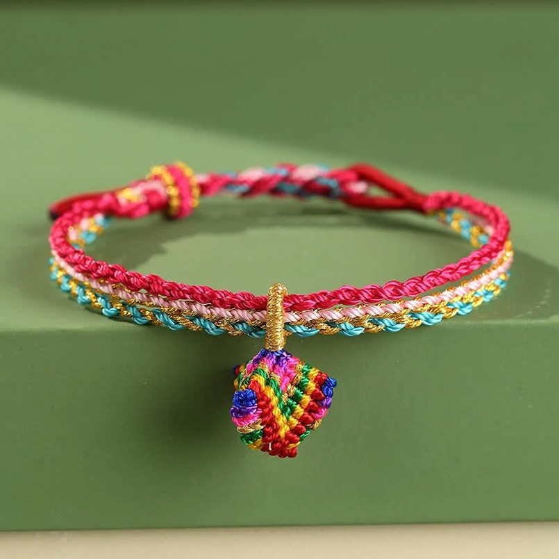 Rose red blue and pink handwoven triple wrap bracelet with traditional Tibetan braiding technique