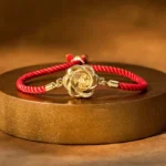 Rotatable plum windmill red string feng shui bracelet top view on wooden base
