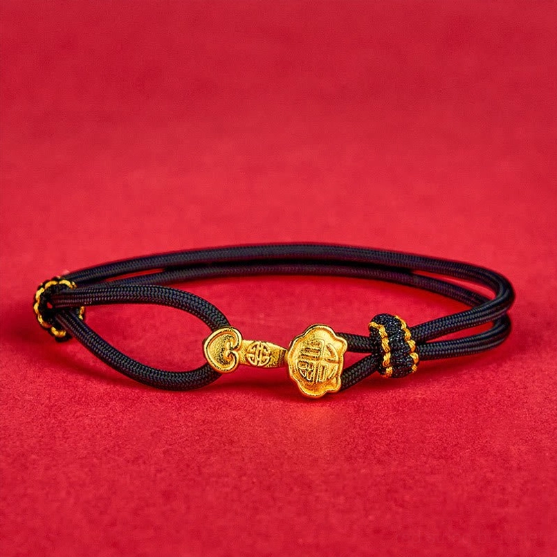 Symmetrical flat lay of black cord Ruyi Fu bracelet showing adjustable design on red background