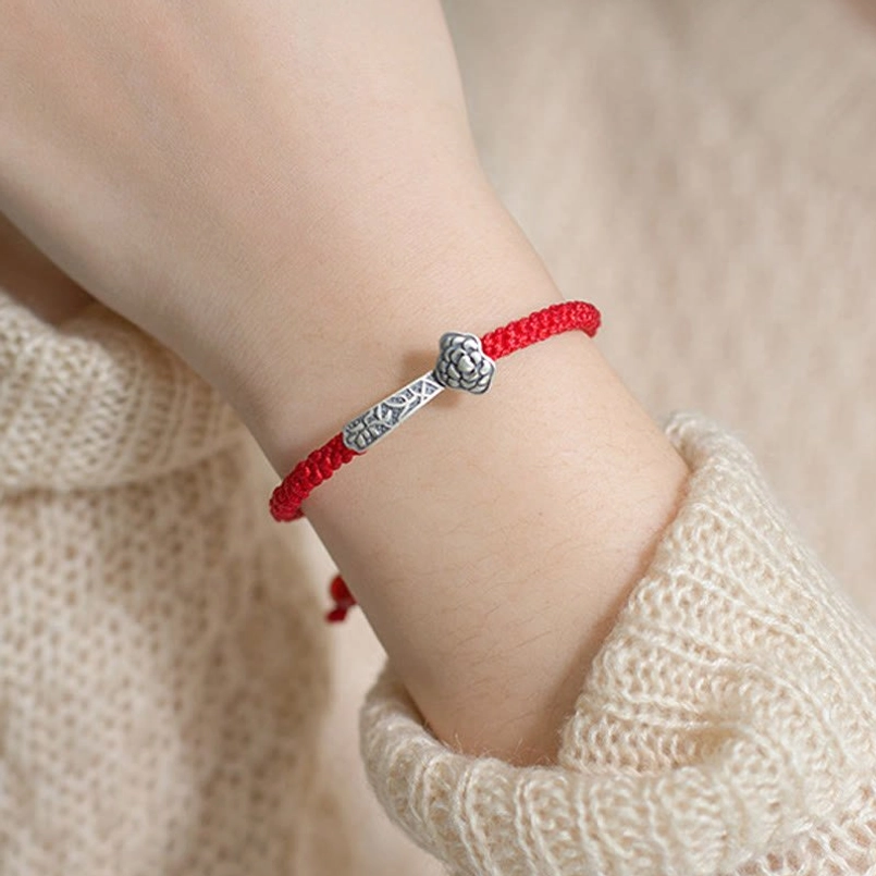 Handmade Ruyi red string lucky bracelet showcasing artisanal weaving and 925 sterling silver wish pendant
