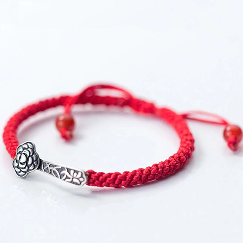 Adjustable red string Ruyi bracelet with 925 silver charm and hanging red bead on pure white background