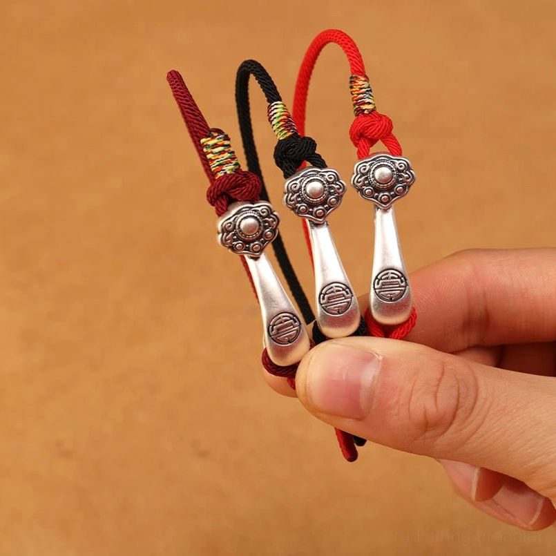 999 sterling silver Ruyi stick bracelet detail shot - showcasing handcrafted quality, braided cord construction, and charm pendant work