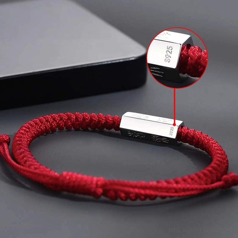 S925 stamped silver charm and adjustable knot red string bracelet flat lay