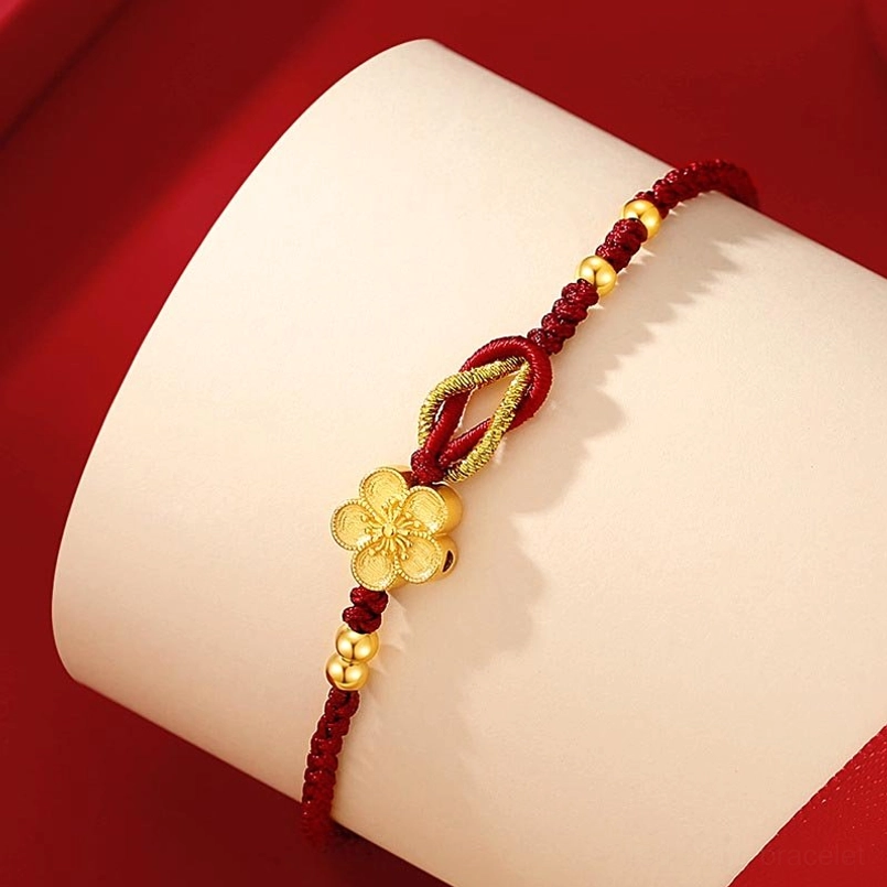 Sakura red string bracelet close-up side view on wrist form dual beige red background