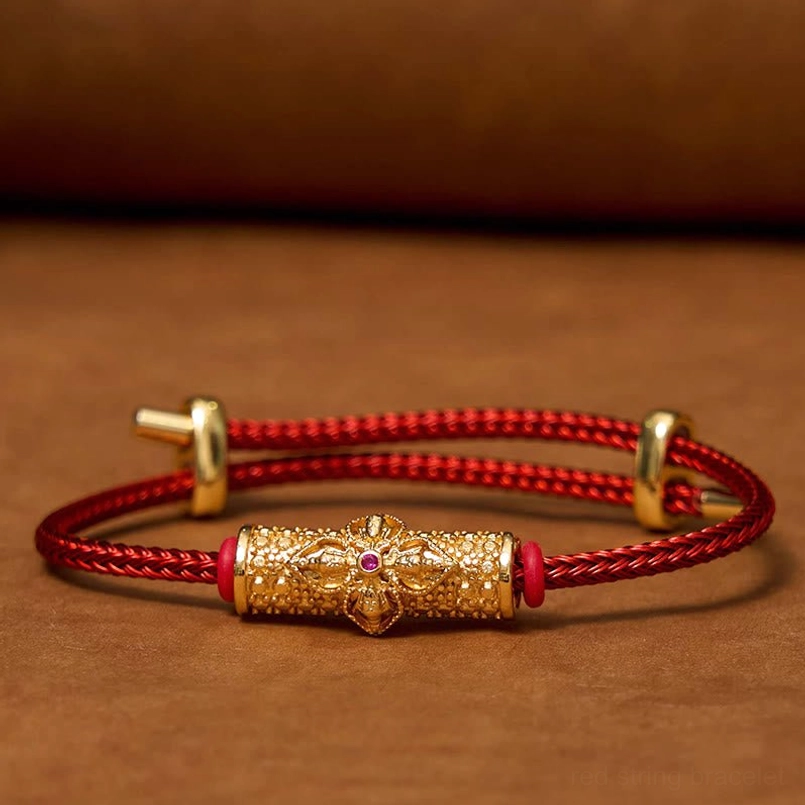 Copper luck red string bracelet with silver metal accents and enamel flower charm close-up