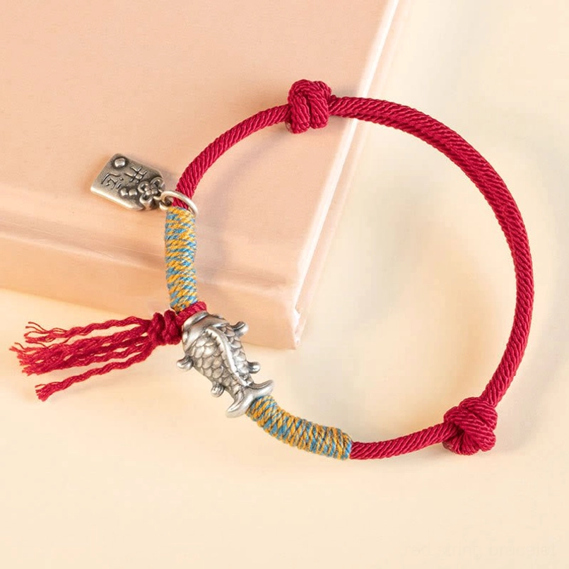 Sterling silver koi fish charm red string bracelet side angle close-up detail