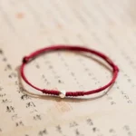 925 sterling silver lucky bead red string bracelet flat lay top view