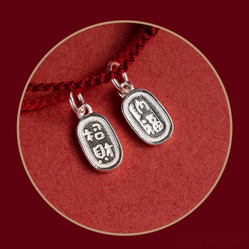 engraved silver lucky fortune charm pendants close-up detail