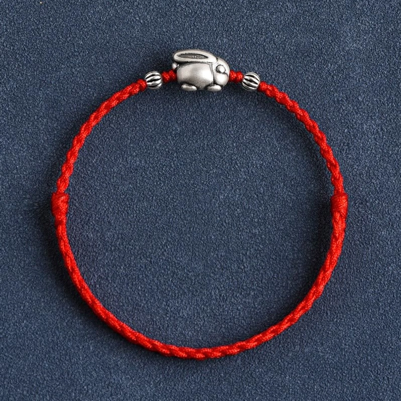 Handmade silver rabbit red cord bracelet top-down circular view