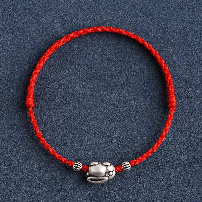 Red string rabbit bracelet full circular layout flat lay photography