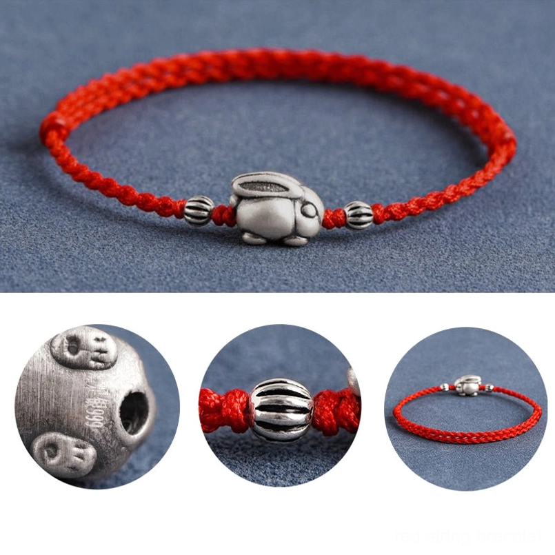 Silver rabbit red rope bracelet clear pendant view on dark background