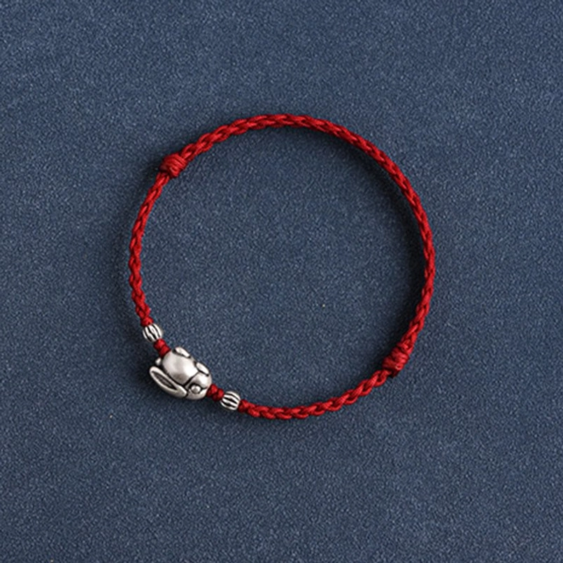 Silver rabbit red cord bracelet lifestyle wear on wrist showing fit