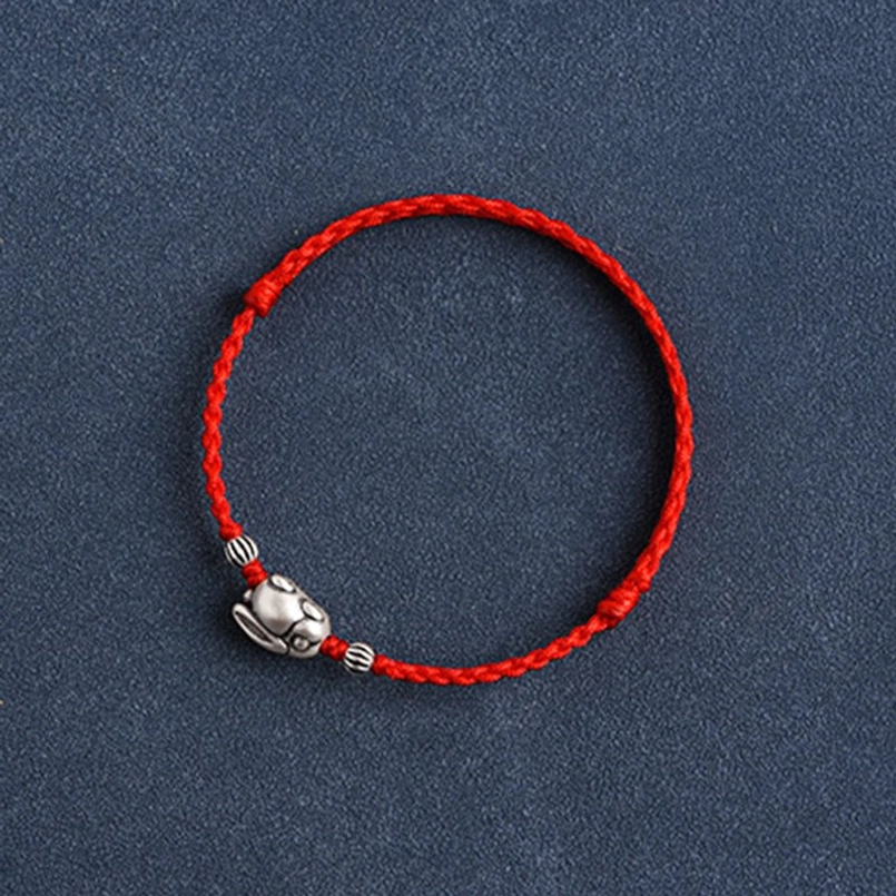 Bottom underside view of silver rabbit charm showing hollow design and marking