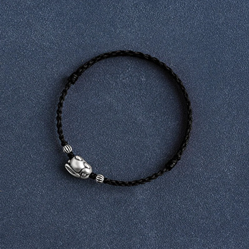 Silver rabbit red cord bracelet close-up showing craftsmanship detail