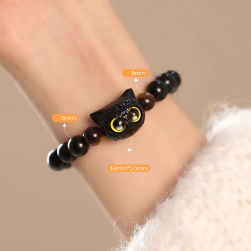 Sized ebony cat head red string bracelet with dimension labels on wrist