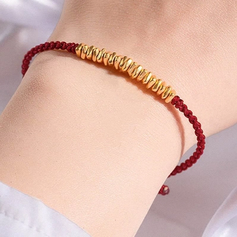slim 999 gold red string bracelet adjustable knot on model wrist