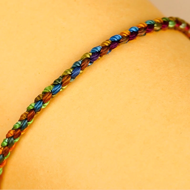 Slim profile multicolored lucky bracelet in tight circular braid with mixed rainbow colors
