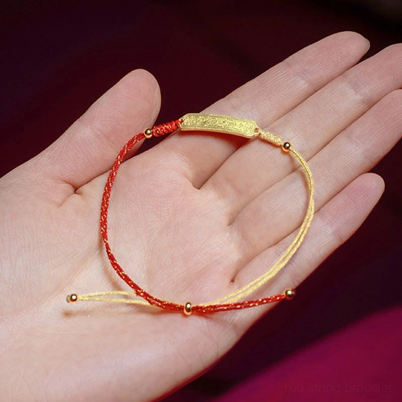 Slim red gold amulet bracelet displayed on human palm
