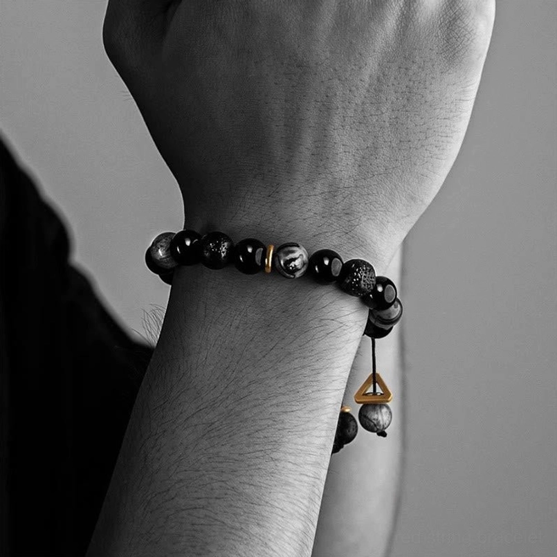 Side close up of slim yin yang red string bracelet worn on male human wrist