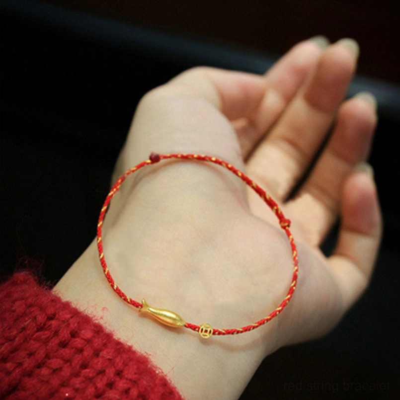 Single small koi fish red string bracelet with pull-style closure worn on wrist