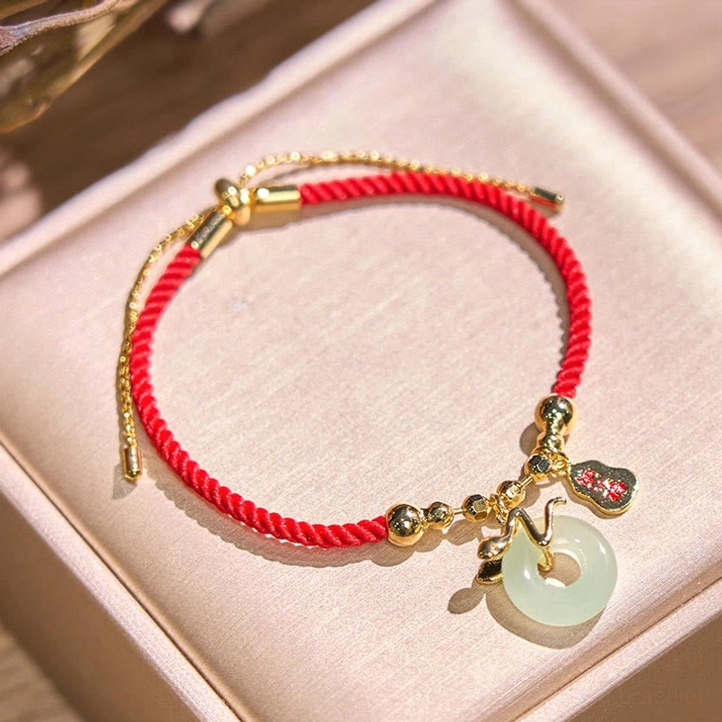 Year of the Snake red string bracelet in velvet jewelry box packaging