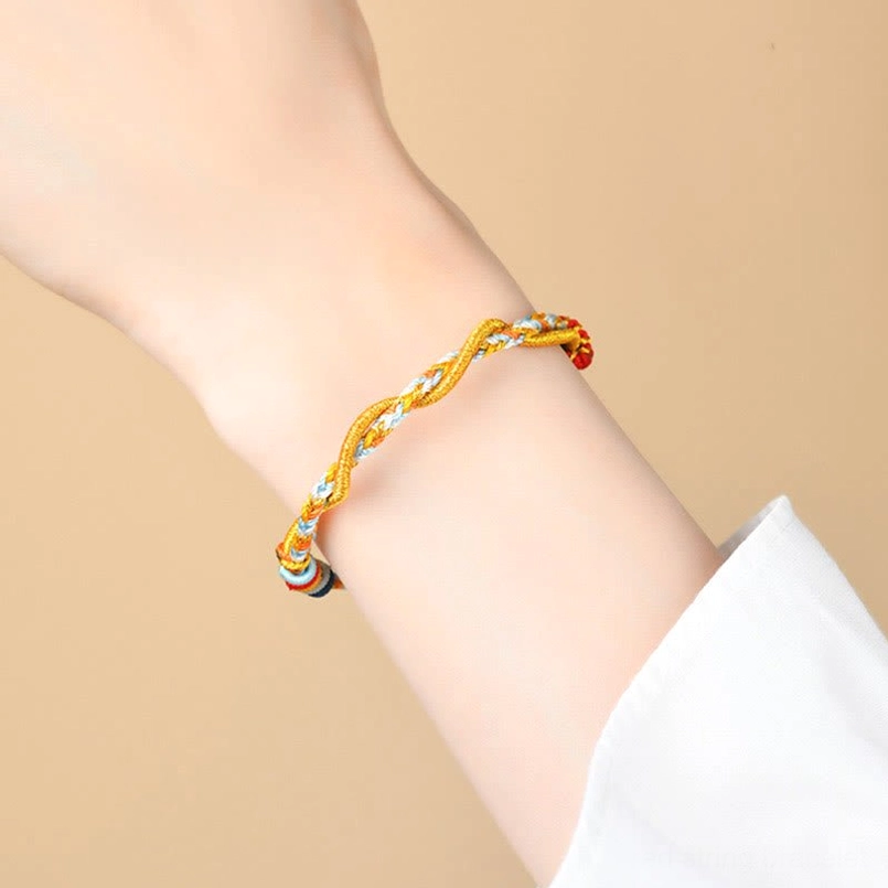 Snake Year luck bracelet worn on wrist showing slim fit and red-gold decorative clasp