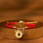 Year of the Snake red string bracelet with jade peace buckle and fu charm - top view