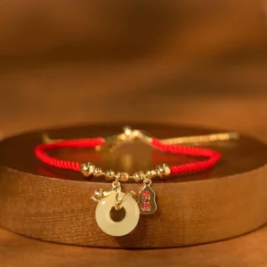 Year of the Snake red string bracelet with jade peace buckle and fu charm - top view